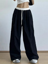 Black wide leg drawstring casual pants with white elastic waistband and matching drawstring for comfortable wear
