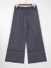 Dark gray terry knit wide-leg pants with elastic waistband and flower patch mineral washed faded texture