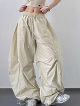 Beige oversized baggy wide leg cargo pants with elastic waistband and drawstring for comfortable wear
