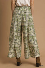 Olive green umgee bohemian print pants with white and black paisley pattern elastic waistband and pockets