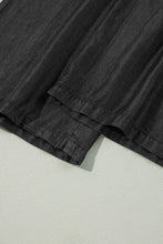 Black linen shorts with relaxed texture and neatly stitched hems featuring a smocked high waist design