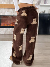 Brown fluffy pants with a beige teddy bear print featuring a repeating bear pattern for cozy wear