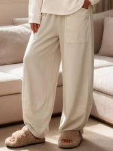 Cream-colored plus size relaxed fit casual pants with loose fit and large front pockets for comfortable wear