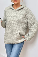 Light gray quilted long sleeve hoodie with hood, pockets, and full sleeve length
