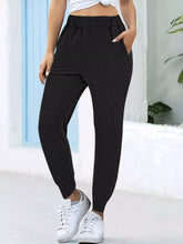 Black high-waisted casual pants with comfortable elastic waist, side pockets, and elastic cuffs for daily wear