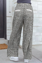 Wide leg terry knit animal print pants with soft flowing fabric and cream patch pockets in leopard print design