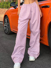 Light pink wide leg pants with elastic waist wide and white side stripes for comfortable casual wear