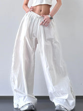 White loose-fitting wide-leg pants with elastic waist and drawstring for comfortable casual wear