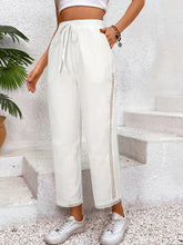 White wide leg cropped pants with drawstring waistband and lace trim on side seams for stylish casual wear