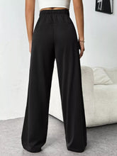 Black drawstring wide leg pants with elastic waistband and high waist for comfortable casual wear