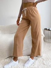 Beige wide leg drawstring casual pants with side seam detailing designed for comfortable everyday wear