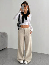 Beige corduroy wide-leg pants with corduroy texture, front pockets, relaxed high-rise fit, perfect for ankle boots