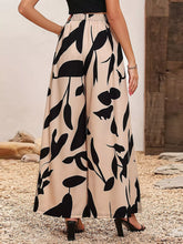 Beige and black leaf-patterned printed wide leg pants with elastic waistband for comfortable casual wear