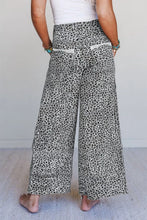 Animal print wide leg terry knit pants in soft flowing fabric with leopard print and white contrast stitching
