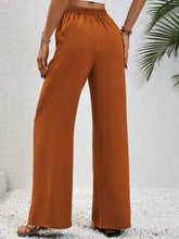 Cropped wide leg drawstring pants in vibrant orange with elastic waistband and relaxed fit for comfortable wear