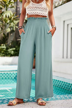 Light blue devine smocked wide leg pants with smocked waistband and side pockets for comfortable wear