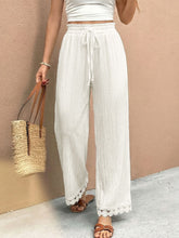 White wide leg pants with lace trim wide hem and drawstring waist for elegant casual wear