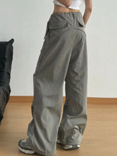 Gray wide leg drawstring pants with a relaxed fit and multiple cargo pockets ideal for casual wear