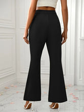 Black high-waisted slit flare pants with pockets in smooth tailored fabric perfect for stylish formal wear