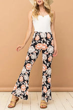 Black floral print wide-leg flare pants in wrinkle-free stretch fabric with peach and white blossoms