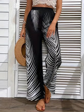 Printed wide leg pants featuring black and white leaf-patterned lightweight flowing fabric for a stylish look