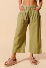 Olive green so me mid rise wide leg chino pants with pleated front pockets and care instructions for maintenance