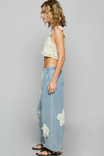 Light blue denim wide-leg twill pants with white floral patch and pol floral pattern featuring crochet see thru patch