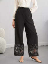 Black wide-leg trousers featuring a delicate floral lace hem trim for an elegant lace hem wide look