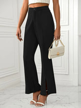Black high-waisted slit flare pants with wide legs front slit button closure and pockets for stylish comfort