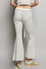 Off-white textured ribbed knit flare pants with ribbed waistband and subtle vertical seam detailing from pol drawstring collection
