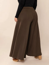 Plus size wide leg brown trousers with a smooth flowing fabric high waist and convenient pockets
