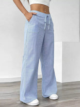 Light blue and white striped wide leg pants with a drawstring waistband in a comfortable wide leg fit