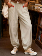 Cream-colored plus size relaxed fit casual pants with large front pockets and a slightly tapered leg for comfort