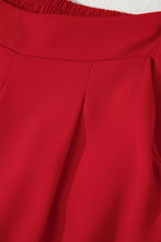 A vibrant red pleated detail pull on high elastic waist loose straight pants with a smooth structured waistband