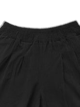 Plus size high waist black wide leg pants with softly pleated fabric and smocked elastic waistband