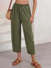 Olive green relaxed-fit cropped pants with drawstring wide leg and subtle textured fabric in plus size design