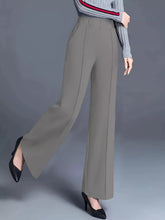 Gray high-waisted wide leg pants with tailored fit and vertical pleats, machine wash and tumble dry care instructions
