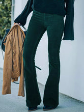 Dark green velvet corduroy flare pants in full size designed for plus size wearers with a soft textured finish