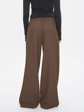 Brown wide leg drawstring pants featuring an elastic waistband for comfortable wear and relaxed fit