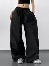 Black letter back wide leg drawstring pants with elastic waistband and cargo pockets for casual wear