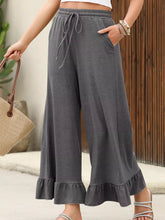 Gray ruffled wide leg pull on high waist pants with drawstring waist and ruffled hems with pockets