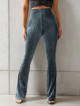 High-waisted ribbed velvet flare pants in textured blue velvet with vertical ribbed stripes for a luxurious velvet look