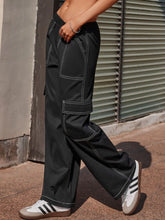 Black wide leg pants with white contrast stitching and multiple cargo pockets for functional style