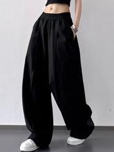 Black oversized wide leg casual pants with soft flowing fabric and subtle pleats machine wash tumble dry care instructions