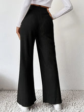 Black ribbed high waist pants with pleated wide legs and flared design perfect for a stylish professional look