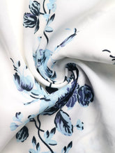 White fabric floral print tie front wide leg pants with delicate light blue and dark navy stylized blossoms and vines