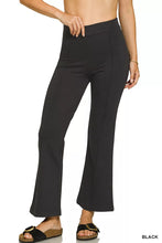 Black high-waisted heavy ponte pintuck pants with elastic waistband and subtle side pleats in smooth stretchy fabric