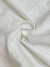 White linen elastic waist pants with subtle textured weave suitable for machine wash cold and easy care