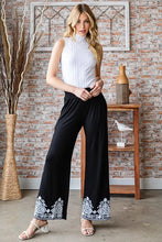 Black wide-leg solid damask casual pants with intricate white embroidered cuffs for plus size wear