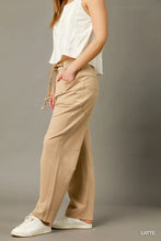 Beige latte-colored umgee cargo-inspired drawstring pants with wide-leg fit and front pockets for casual wear